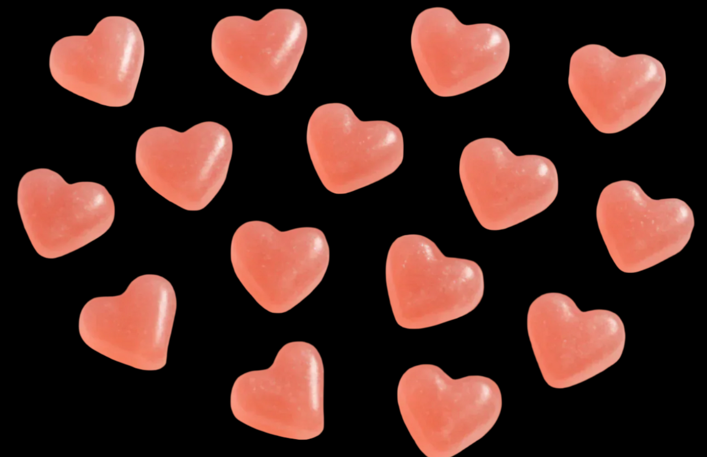 simple white background which heart gumiies that are pink